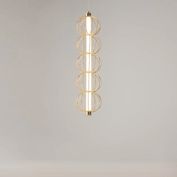 Détail de la suspension cage dorée diffusant une lumière blanche chaude